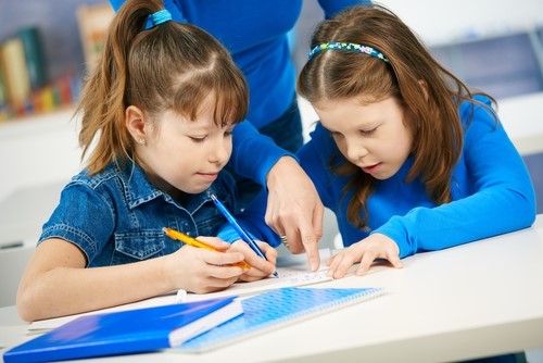 Schoolgirls Learning in Primary Classroom