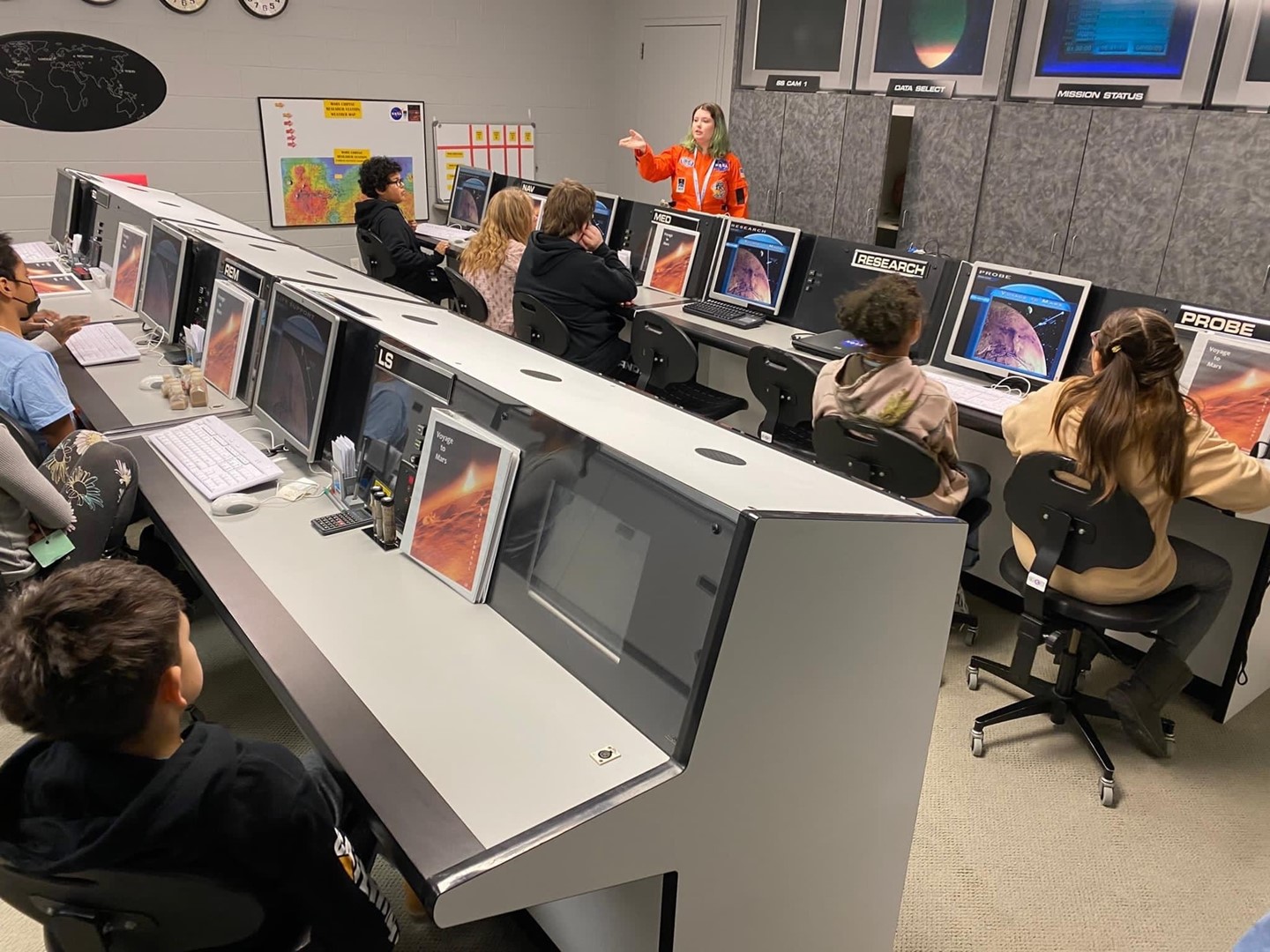 Students sitting at consoles made to look like Nasa&#39;s mission control.